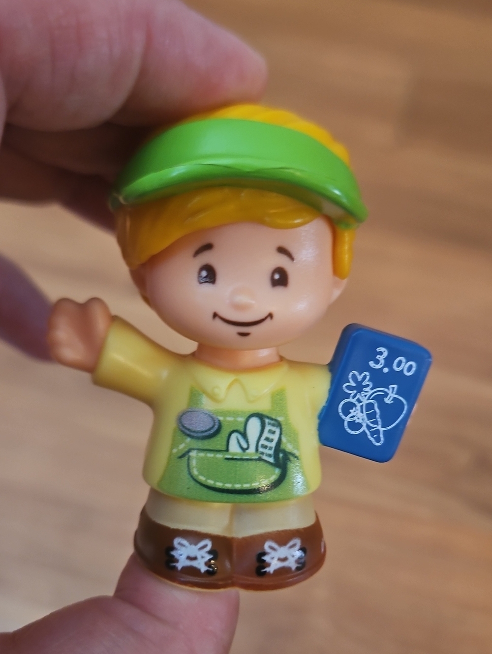 Fisher-Price Little People Eddie figure dressed as a shopkeeper
